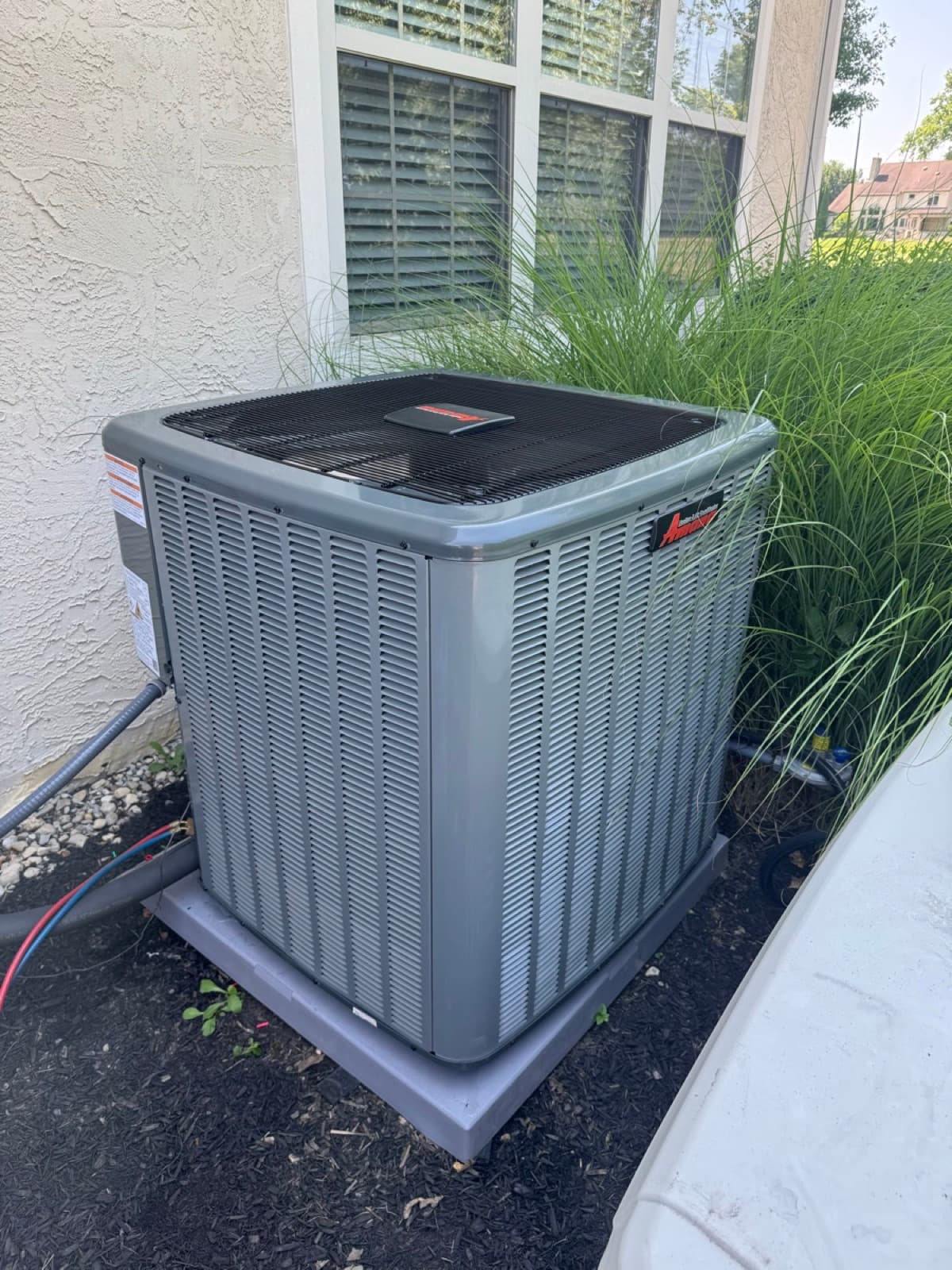 Amana AC condenser installation with landscaping
