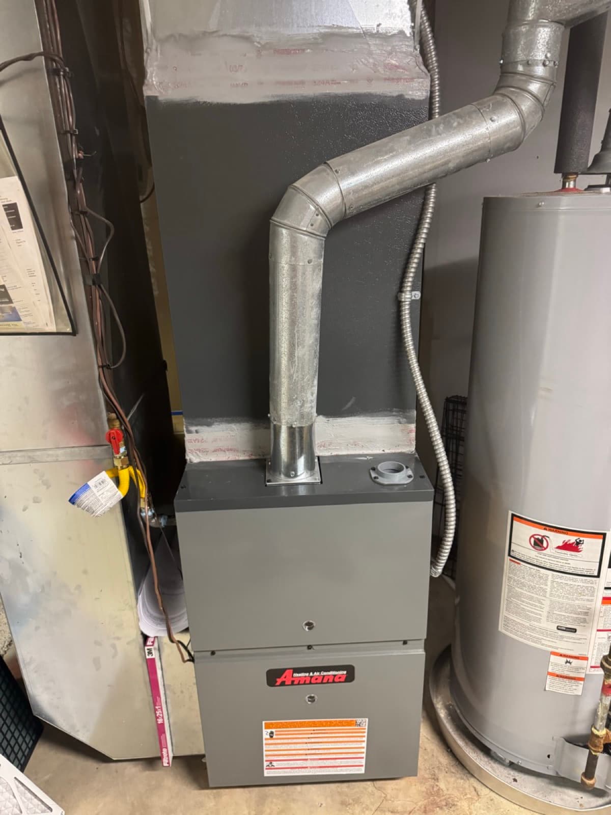 Amana furnace installed in a residential utility room
